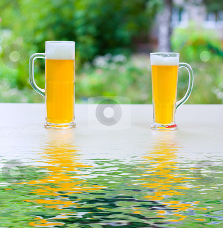 Beer consolidate Beer consolidate stock photo, two human hands, man and woman with beer in glass. by olinchuk