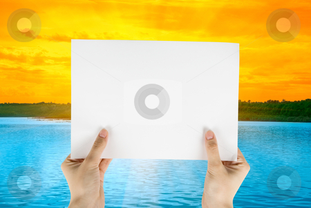 To use this stock image in your creative project, please select the size you need over to the right and click the "Add to Cart" button.
Your downloaded image will come with the Cutcaster watermark removed so don’t worry about the watermark you see on this page. White paper stock photo, Hand holding white paper at beauty sunset on river background by olinchuk