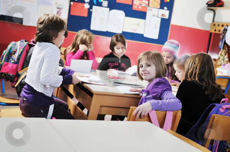 To use this stock image in your creative project, please select the size you need over to the right and click the "Add to Cart" button.
Your downloaded image will come with the Cutcaster watermark removed so don’t worry about the watermark you see on this page. Happy kids with teacher in school classroom stock photo, happy young teacher woman at elementrary school teaching and giving leassons to group of young smart children by Benis Arapovic