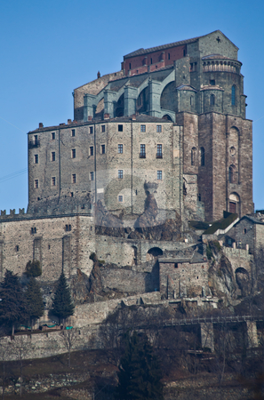 To use this stock image in your creative project, please select the size you need over to the right and click the "Add to Cart" button.
Your downloaded image will come with the Cutcaster watermark removed so don’t worry about the watermark you see on this page. Sacra di San Michele - Italy stock photo, Abbey of 11st century, Piedmont region, Italy. The church, whose construction lasted for many years, is characterized by the unusual position and architecture. by Perseomedusa