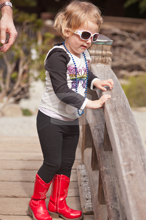 Maya in red boots Maya in red boots stock photo, First spring walk in park on sunny day. by Mariusz Jurgielewicz