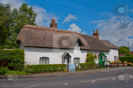 To use this stock image in your creative project, please select the size you need over to the right and click the "Add to Cart" button.
Your downloaded image will come with the Cutcaster watermark removed so don’t worry about the watermark you see on this page. Thatched Roof English Cottage stock photo, Traditional English country cottage exterior with flowers on display. by liverbird