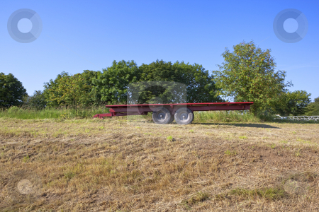 To use this stock image in your creative project, please select the size you need over to the right and click the "Add to Cart" button.
Your downloaded image will come with the Cutcaster watermark removed so don’t worry about the watermark you see on this page. Red trailer stock photo, a red trailer in a newly cut hay field with a background of trees under a clear blue sky by Mike Smith