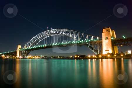 To use this stock image in your creative project, please select the size you need over to the right and click the "Add to Cart" button.
Your downloaded image will come with the Cutcaster watermark removed so don’t worry about the watermark you see on this page. Sydney Harbour Bridge By Night stock photo, Sydney Harbour Bridge By Night with sparkling water reflection by mroz