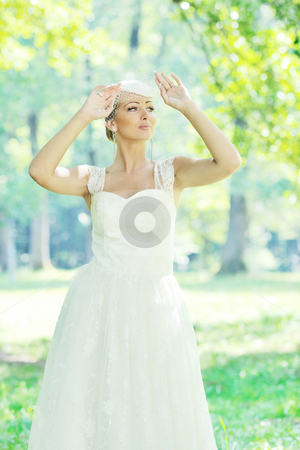 To use this stock image in your creative project, please select the size you need over to the right and click the "Add to Cart" button.
Your downloaded image will come with the Cutcaster watermark removed so don’t worry about the watermark you see on this page. Beautiful bride outdoor stock photo, beautiful bride woman people in fashion wedding dress posing outdoor in bright park by Benis Arapovic