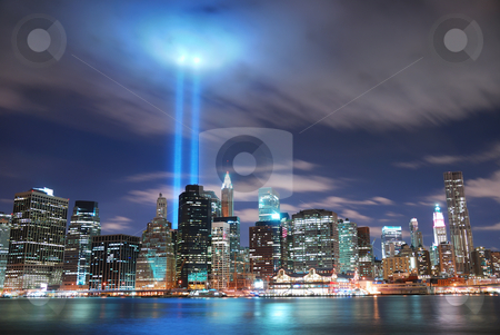 New York City Manhattan at night New York City Manhattan at night stock photo, Remember September 11. New York City Manhattan panorama view at night with office building skyscrapers skyline illuminated over Hudson River and two light beam in memory of September 11. by rabbit75_cut