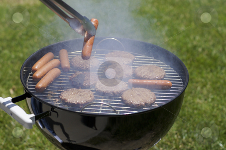 To use this stock image in your creative project, please select the size you need over to the right and click the "Add to Cart" button.
Your downloaded image will come with the Cutcaster watermark removed so don’t worry about the watermark you see on this page. Backyard BBQ stock photo, cooking hamburgers and hotdogs on a grill by Robby Ticknor