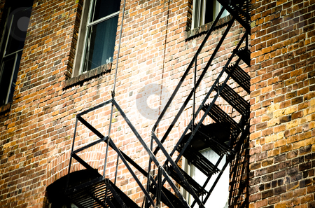 Fire escape stairs Fire escape stairs stock photo, an old bricks building and black fire escape stairs by Anatoliy Nykilchyk