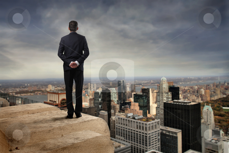 To use this stock image in your creative project, please select the size you need over to the right and click the "Add to Cart" button.
Your downloaded image will come with the Cutcaster watermark removed so don’t worry about the watermark you see on this page. Progress stock photo, Rear view of a businessman on the top of a skyscraper observing a city by olly4