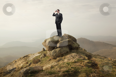 Progress Progress stock photo, Businessman standing on a rock and using binoculars by olly4