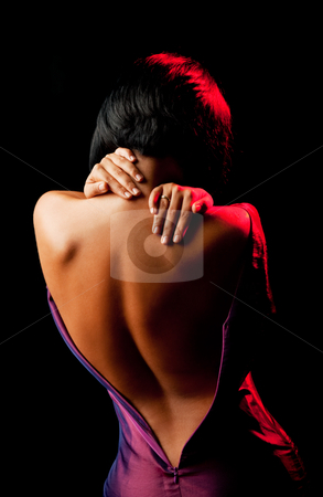 Undressing female Undressing female stock photo, female seen from the back, undressing and holding her neck by vilevi