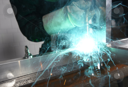 Welder with sparks Welder with sparks stock photo, Welder with sparks arcing in a cyan light by sielemann