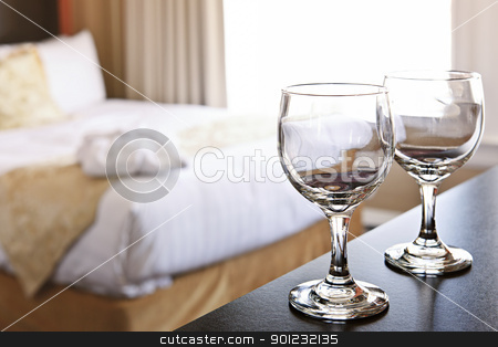 To use this stock image in your creative project, please select the size you need over to the right and click the "Add to Cart" button.
Your downloaded image will come with the Cutcaster watermark removed so don’t worry about the watermark you see on this page. Wineglasses in hotel room stock photo, Romantic bedroom with wine glasses in luxury hotel interior by Elena Elisseeva