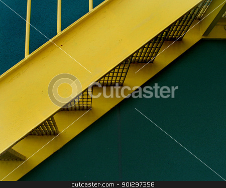To use this stock image in your creative project, please select the size you need over to the right and click the "Add to Cart" button.
Your downloaded image will come with the Cutcaster watermark removed so don’t worry about the watermark you see on this page. Yellow Staircase stock photo, A detail image of a yellow grated stairway infront of a green building by Tyler Olson