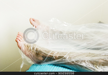 To use this stock image in your creative project, please select the size you need over to the right and click the "Add to Cart" button.
Your downloaded image will come with the Cutcaster watermark removed so don’t worry about the watermark you see on this page. Full Body Wrap stock photo, A detail image of the feet wrapped in during a sea mud full body wrap at a luxury spa. by Tyler Olson