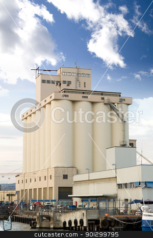 To use this stock image in your creative project, please select the size you need over to the right and click the "Add to Cart" button.
Your downloaded image will come with the Cutcaster watermark removed so don’t worry about the watermark you see on this page. Granary Shipping Port stock photo, An ocean seaside port with a grain terminal and ferry by Tyler Olson