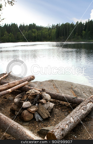 To use this stock image in your creative project, please select the size you need over to the right and click the "Add to Cart" button.
Your downloaded image will come with the Cutcaster watermark removed so don’t worry about the watermark you see on this page. Campsite stock photo, A campsite by a lake in nature with a fire pit by Tyler Olson