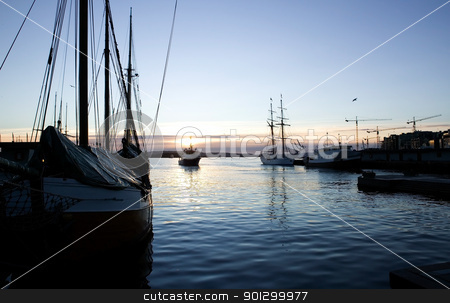 To use this stock image in your creative project, please select the size you need over to the right and click the "Add to Cart" button.
Your downloaded image will come with the Cutcaster watermark removed so don’t worry about the watermark you see on this page. Dock at Dusk stock photo, The Oslo fjord dock at dusk - akerbrygge with a new metal boat and an older wooden ship by Tyler Olson