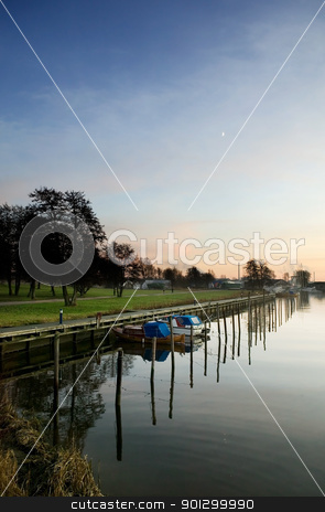 To use this stock image in your creative project, please select the size you need over to the right and click the "Add to Cart" button.
Your downloaded image will come with the Cutcaster watermark removed so don’t worry about the watermark you see on this page. Harbor at Sunset stock photo, A boat harbor in the late fall painted in the evening light of sunset by Tyler Olson