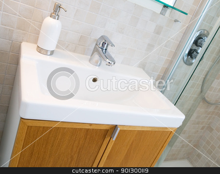 To use this stock image in your creative project, please select the size you need over to the right and click the "Add to Cart" button.
Your downloaded image will come with the Cutcaster watermark removed so don’t worry about the watermark you see on this page. Bathroom Sink stock photo, A standard new bathroom sink with tiles on the wall. by Tyler Olson