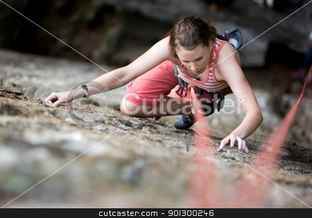 To use this stock image in your creative project, please select the size you need over to the right and click the "Add to Cart" button.
Your downloaded image will come with the Cutcaster watermark removed so don’t worry about the watermark you see on this page. Female Climber stock photo, A female climber on a steep rock face viewed from above with the belayer in the background. Shallow depth of field is used to isolated the climber. by Tyler Olson