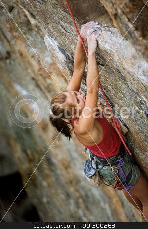 To use this stock image in your creative project, please select the size you need over to the right and click the "Add to Cart" button.
Your downloaded image will come with the Cutcaster watermark removed so don’t worry about the watermark you see on this page. Female Climber stock photo, An eager female climber on a steep rock face looks for the next hold - viewed from above. Shallow depth of field is used to isolated the climber with the focus on the head. by Tyler Olson