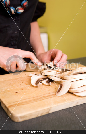 To use this stock image in your creative project, please select the size you need over to the right and click the "Add to Cart" button.
Your downloaded image will come with the Cutcaster watermark removed so don’t worry about the watermark you see on this page. Slicing Mushrooms Detail stock photo, A woman cutting mushrooms at home on the counter by Tyler Olson
