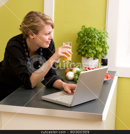 To use this stock image in your creative project, please select the size you need over to the right and click the "Add to Cart" button.
Your downloaded image will come with the Cutcaster watermark removed so don’t worry about the watermark you see on this page. Lunch with Laptop stock photo, A female eating lunch while using the laptop at home in the kicthen. by Tyler Olson
