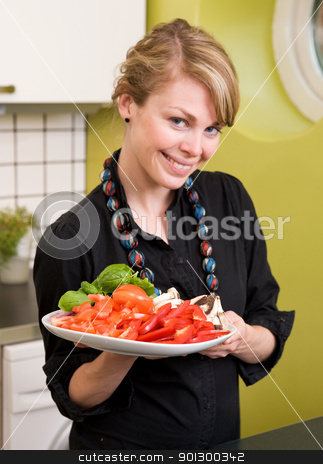 To use this stock image in your creative project, please select the size you need over to the right and click the "Add to Cart" button.
Your downloaded image will come with the Cutcaster watermark removed so don’t worry about the watermark you see on this page. Freshly Cut Vegetables stock photo, A female in the kitchen looking down on a tasty plate of vegetables by Tyler Olson