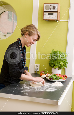 To use this stock image in your creative project, please select the size you need over to the right and click the "Add to Cart" button.
Your downloaded image will come with the Cutcaster watermark removed so don’t worry about the watermark you see on this page. Making Pizza Dough stock photo, A young woman is making pizza dough on the kitchen counter at home in her apartment. by Tyler Olson