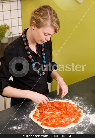 To use this stock image in your creative project, please select the size you need over to the right and click the "Add to Cart" button.
Your downloaded image will come with the Cutcaster watermark removed so don’t worry about the watermark you see on this page. Homemade Italian Style Pizza stock photo, A young female making an italian style pizza at home in her apartment kitchen. by Tyler Olson