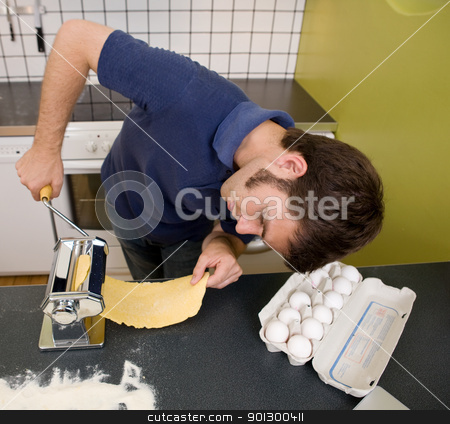 To use this stock image in your creative project, please select the size you need over to the right and click the "Add to Cart" button.
Your downloaded image will come with the Cutcaster watermark removed so don’t worry about the watermark you see on this page. Happy Pasta Making stock photo, A happy male in the kitchen making pasta by hand by Tyler Olson