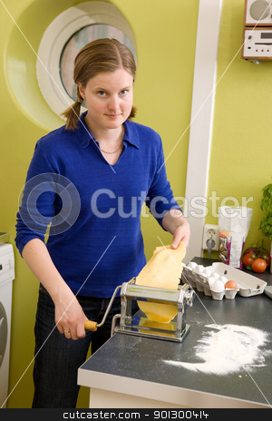To use this stock image in your creative project, please select the size you need over to the right and click the "Add to Cart" button.
Your downloaded image will come with the Cutcaster watermark removed so don’t worry about the watermark you see on this page. Woman Making Homemade Pasta stock photo, A young woman is making pasta on the counter in her apartment kitchen. by Tyler Olson