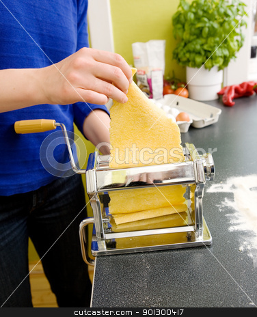 To use this stock image in your creative project, please select the size you need over to the right and click the "Add to Cart" button.
Your downloaded image will come with the Cutcaster watermark removed so don’t worry about the watermark you see on this page. Making Pasta at Home stock photo, A young female makes pasta at home in the kicthen; by Tyler Olson