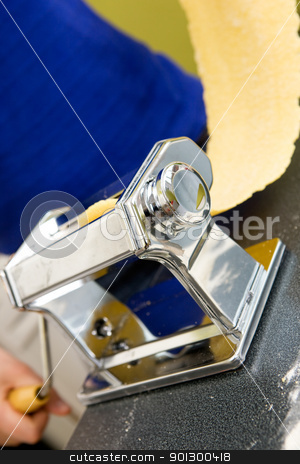 To use this stock image in your creative project, please select the size you need over to the right and click the "Add to Cart" button.
Your downloaded image will come with the Cutcaster watermark removed so don’t worry about the watermark you see on this page. Pasta Machine stock photo, A young female stretching out pasta over the counter from a manual pasta machine at home in the kitchen. by Tyler Olson
