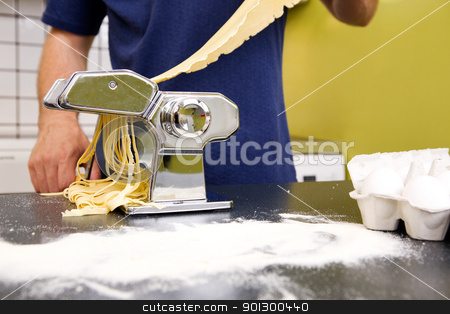 To use this stock image in your creative project, please select the size you need over to the right and click the "Add to Cart" button.
Your downloaded image will come with the Cutcaster watermark removed so don’t worry about the watermark you see on this page. Making Fettuccine stock photo, Fettuccine coming out of a manual pasta machine by Tyler Olson