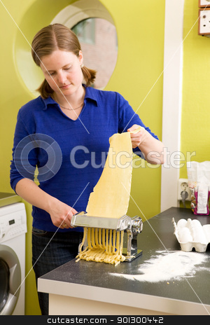 To use this stock image in your creative project, please select the size you need over to the right and click the "Add to Cart" button.
Your downloaded image will come with the Cutcaster watermark removed so don’t worry about the watermark you see on this page. Female making Fettuccine stock photo, Fettuccine coming out of a manual pasta machine by Tyler Olson