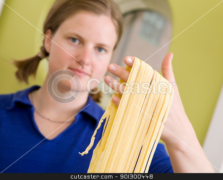 To use this stock image in your creative project, please select the size you need over to the right and click the "Add to Cart" button.
Your downloaded image will come with the Cutcaster watermark removed so don’t worry about the watermark you see on this page. Homemade Pasta Fettuccine Detail stock photo, A proud young woman with fresh homemade fettuccine looks at the camera- shallow depth of field with focus on the pasta by Tyler Olson