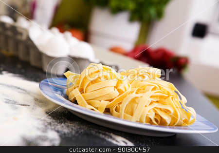 To use this stock image in your creative project, please select the size you need over to the right and click the "Add to Cart" button.
Your downloaded image will come with the Cutcaster watermark removed so don’t worry about the watermark you see on this page. Fresh Fettuccine stock photo, A detail of homemade fettuccine on a plate ready to be boiled by Tyler Olson