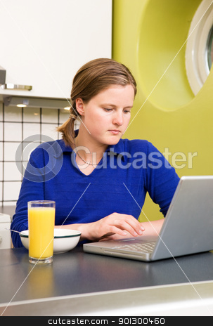 To use this stock image in your creative project, please select the size you need over to the right and click the "Add to Cart" button.
Your downloaded image will come with the Cutcaster watermark removed so don’t worry about the watermark you see on this page. Online Breakfast stock photo, A young woman using the computer at breakfast or eating a meal in the kichen. by Tyler Olson