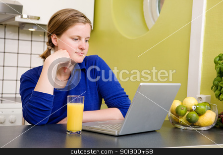 To use this stock image in your creative project, please select the size you need over to the right and click the "Add to Cart" button.
Your downloaded image will come with the Cutcaster watermark removed so don’t worry about the watermark you see on this page. Morning News stock photo, A young woman reads the morning news on a laptop while drinking orange juice by Tyler Olson