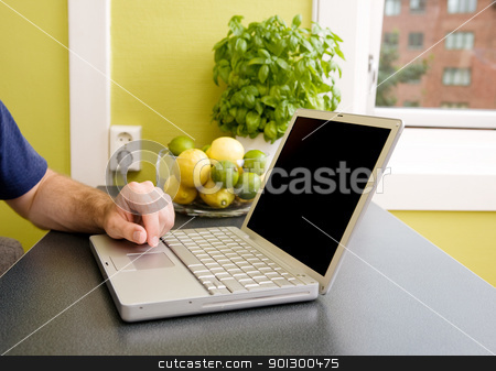 To use this stock image in your creative project, please select the size you need over to the right and click the "Add to Cart" button.
Your downloaded image will come with the Cutcaster watermark removed so don’t worry about the watermark you see on this page. Kitchen Computer stock photo, A computer in the kitchen with a male hand using the touch pad. The laptop has a completely black screen for easy editing. by Tyler Olson