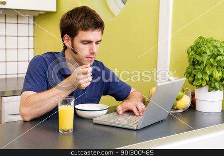 To use this stock image in your creative project, please select the size you need over to the right and click the "Add to Cart" button.
Your downloaded image will come with the Cutcaster watermark removed so don’t worry about the watermark you see on this page. Computer Homework stock photo, A young male works on the computer in the kicthen while eating breakfast by Tyler Olson