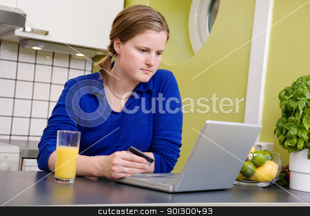 To use this stock image in your creative project, please select the size you need over to the right and click the "Add to Cart" button.
Your downloaded image will come with the Cutcaster watermark removed so don’t worry about the watermark you see on this page. Online Purchase stock photo, A young female making an online purchase from her kitchen. by Tyler Olson