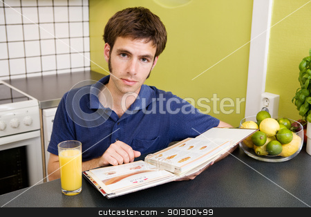 To use this stock image in your creative project, please select the size you need over to the right and click the "Add to Cart" button.
Your downloaded image will come with the Cutcaster watermark removed so don’t worry about the watermark you see on this page. Recipe Book stock photo, A young man in the kitchen looking at recipes. by Tyler Olson