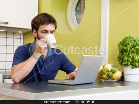 To use this stock image in your creative project, please select the size you need over to the right and click the "Add to Cart" button.
Your downloaded image will come with the Cutcaster watermark removed so don’t worry about the watermark you see on this page. Surfing in Kitchen stock photo, Using a laptop computer in the kitchen while enjoying a warm drink by Tyler Olson