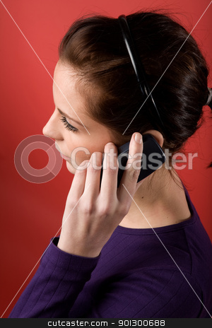To use this stock image in your creative project, please select the size you need over to the right and click the "Add to Cart" button.
Your downloaded image will come with the Cutcaster watermark removed so don’t worry about the watermark you see on this page. Cell Phone stock photo, A young female listening on a cell phone. isolated on red. by Tyler Olson