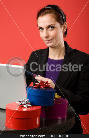 To use this stock image in your creative project, please select the size you need over to the right and click the "Add to Cart" button.
Your downloaded image will come with the Cutcaster watermark removed so don’t worry about the watermark you see on this page. Online Christmas Shopping stock photo, A young female shopping for christmas presents online by Tyler Olson