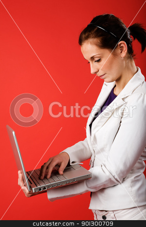 To use this stock image in your creative project, please select the size you need over to the right and click the "Add to Cart" button.
Your downloaded image will come with the Cutcaster watermark removed so don’t worry about the watermark you see on this page. Wireless Communication stock photo, A young business woman or student using a laptop with a strong red background by Tyler Olson
