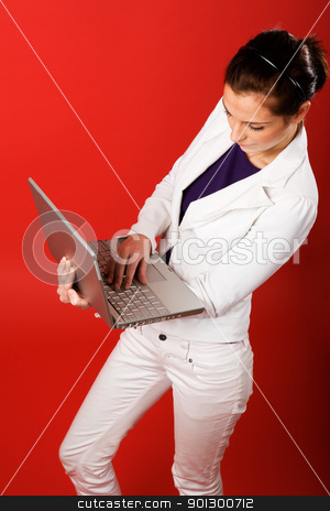 To use this stock image in your creative project, please select the size you need over to the right and click the "Add to Cart" button.
Your downloaded image will come with the Cutcaster watermark removed so don’t worry about the watermark you see on this page. Red Studio Laptop stock photo, A young business woman or student using a laptop by Tyler Olson